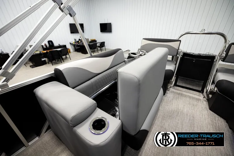 Slide: The Image of 2026 Avalon LSZ QLS boat interior with modern seating and cup holders in showroom. - 22
