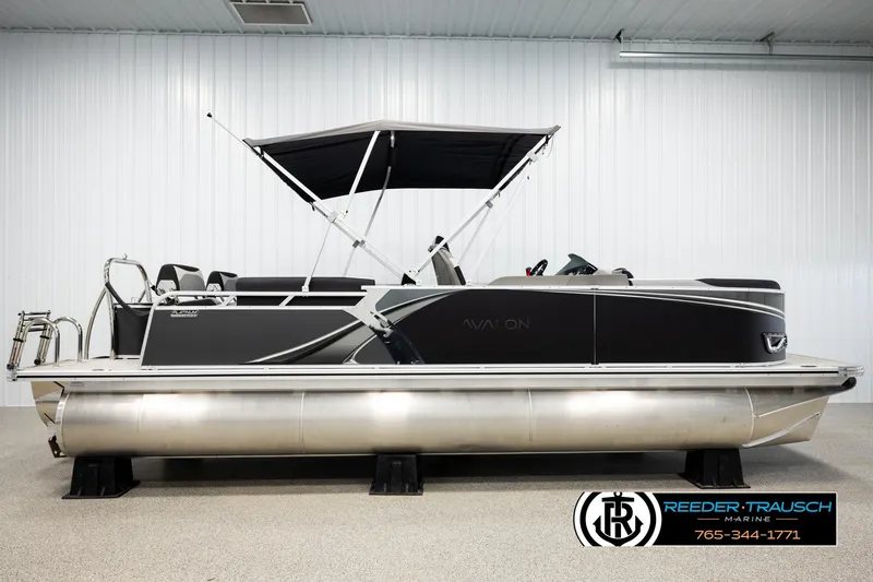 Slide: The Image of 2026 Avalon LSZ QLS pontoon boat with canopy in showroom, side view. - 5