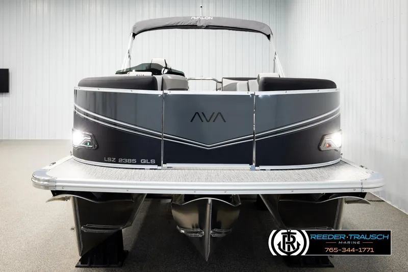 Slide: The Image of 2026 Avalon LSZ QLS pontoon boat in showroom, front view with sleek design. - 8