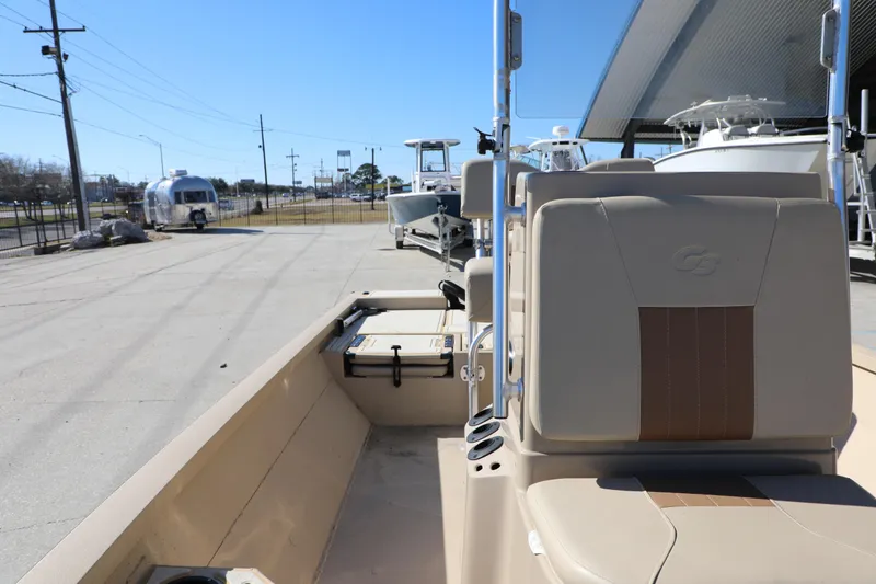 Slide: The Image of 2022 G3 Bay 20 GX boat with beige seating, parked outdoors under clear blue sky. - 8
