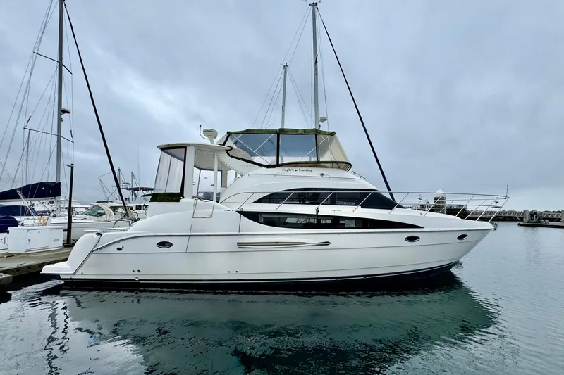 The Image of 2007 Meridian 459 Motoryacht docked in a marina, overcast sky. - 0