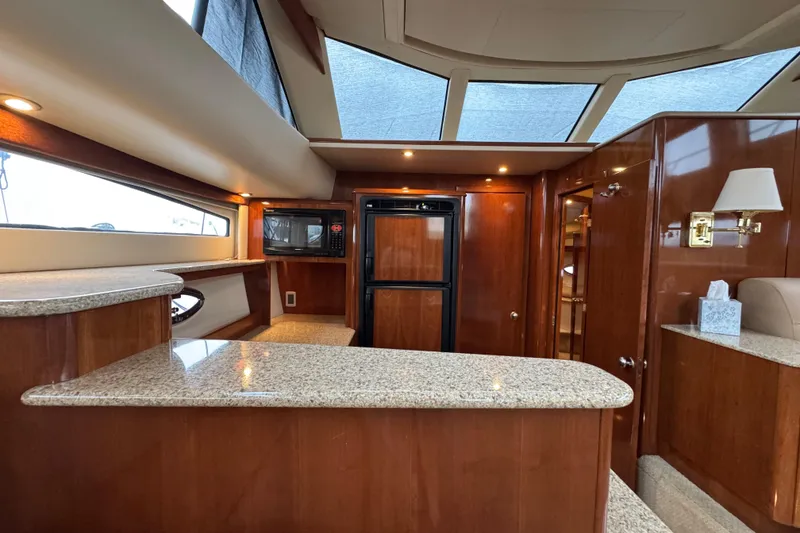 Slide: The Image of Luxurious 2007 Meridian 459 Motoryacht interior with modern kitchen and elegant wood finishes. - 11