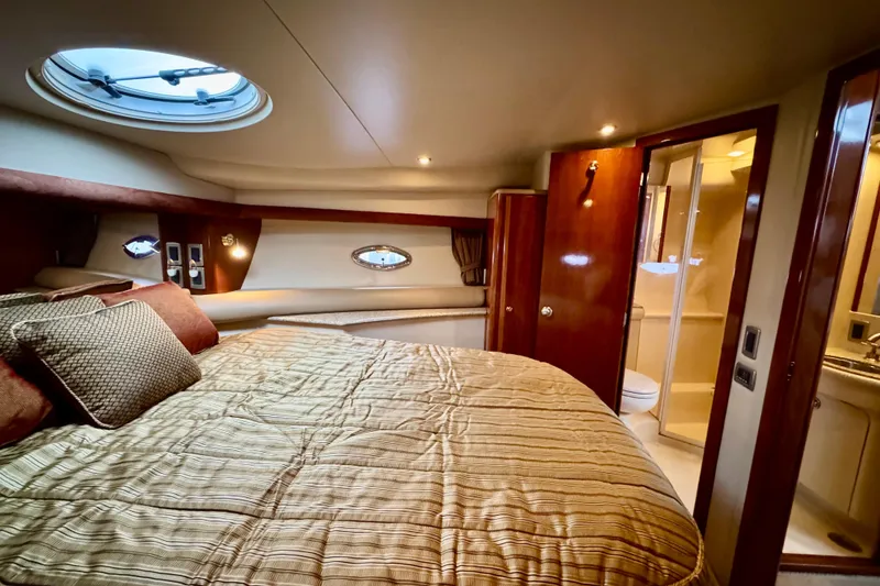 Slide: The Image of Luxurious 2007 Meridian 459 Motoryacht bedroom with ensuite bathroom and elegant decor. - 13