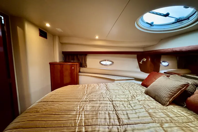 Slide: The Image of Luxurious 2007 Meridian 459 Motoryacht cabin with cozy bedding and elegant wood finishes. - 14