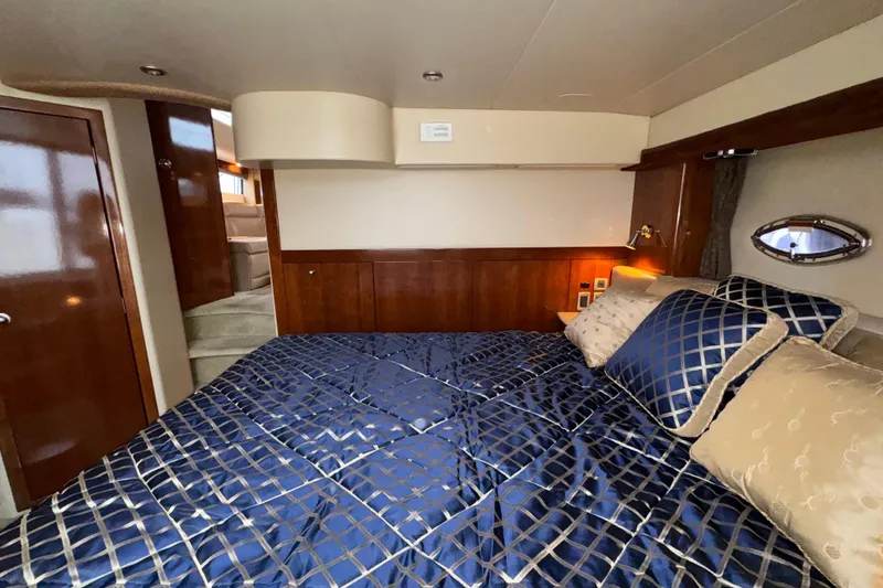 Slide: The Image of Luxurious bedroom interior of 2007 Meridian 459 Motoryacht with elegant bedding and wood accents. - 24
