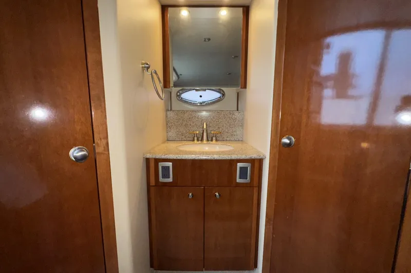 Slide: The Image of 2007 Meridian 459 Motoryacht bathroom with wooden cabinets and granite countertop. - 25