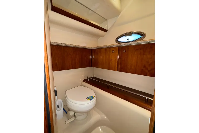 Slide: The Image of Luxurious bathroom in 2007 Meridian 459 Motoryacht with wood accents and porthole window. - 26