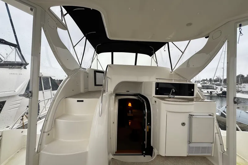Slide: The Image of 2007 Meridian 459 Motoryacht interior with stairs, sink, and marina view. - 28