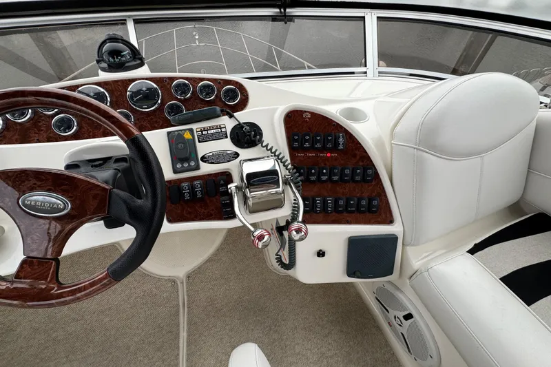 Slide: The Image of 2007 Meridian 459 Motoryacht helm with wood accents and control panel. - 35