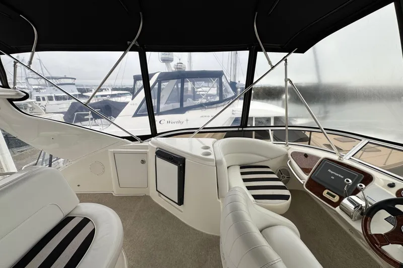 Slide: The Image of 2007 Meridian 459 Motoryacht helm with striped seating and navigation equipment. - 36