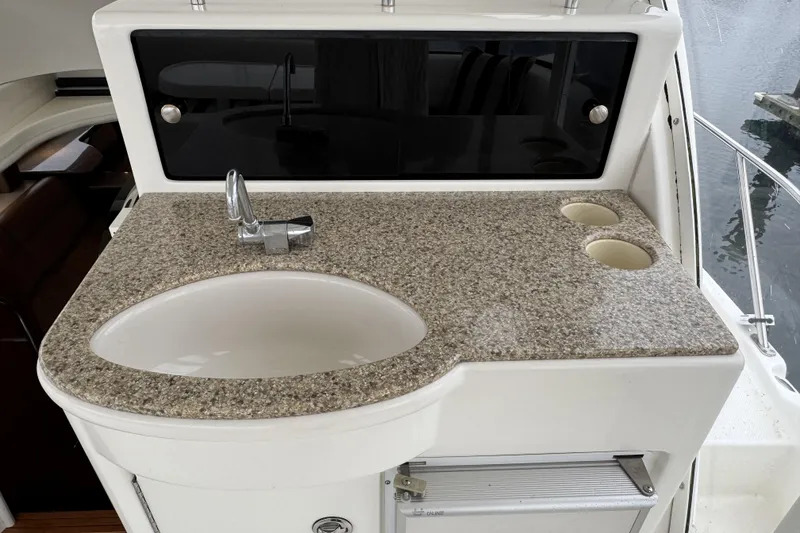 Slide: The Image of 2007 Meridian 459 Motoryacht sink area with granite countertop and storage. - 38