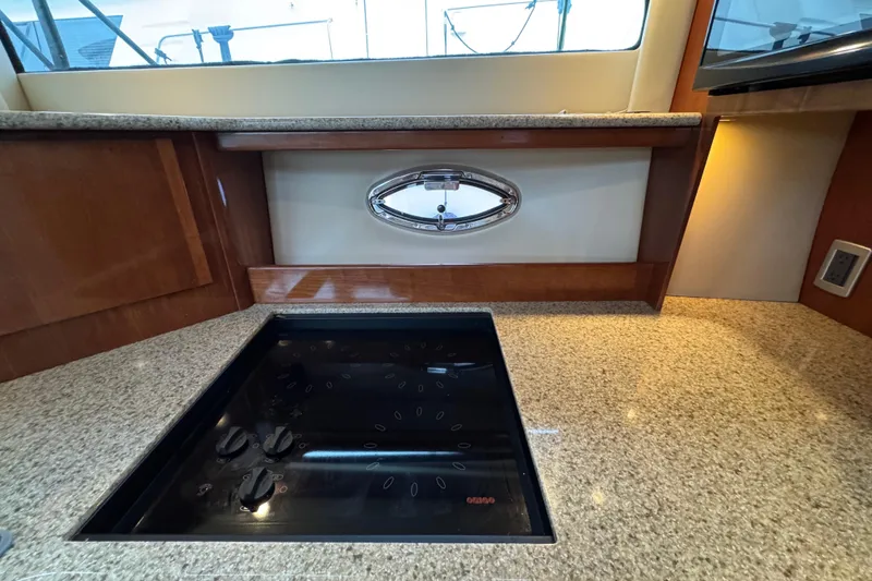 Slide: The Image of 2007 Meridian 459 Motoryacht kitchen with granite countertops and modern stovetop. - 40