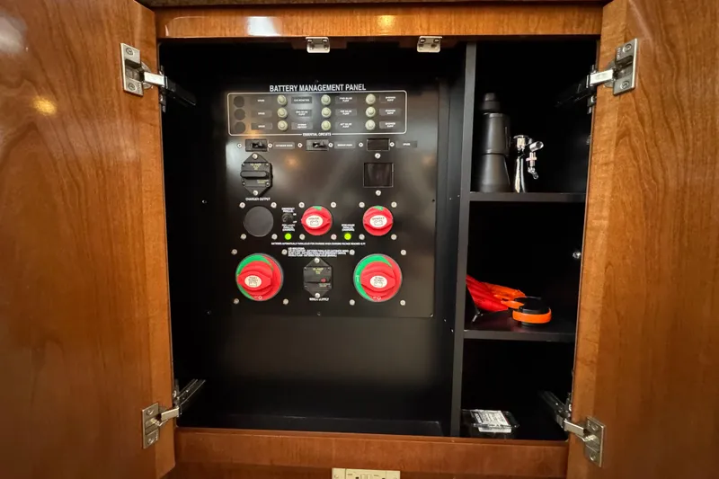 Slide: The Image of Battery management panel inside 2007 Meridian 459 Motoryacht cabinet with storage shelves. - 42