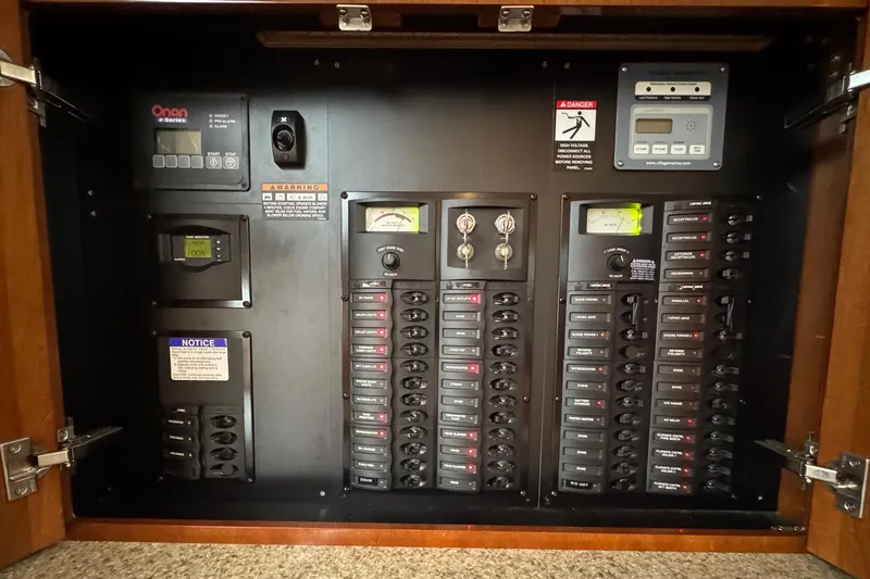 Slide: The Image of Electrical control panel inside a 2007 Meridian 459 Motoryacht, featuring various switches and meters. - 43