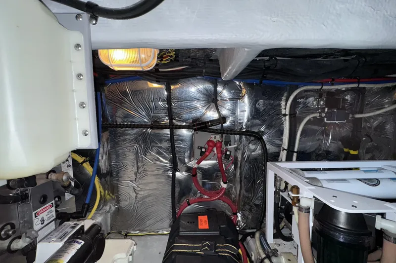Slide: The Image of Engine room of a 2007 Meridian 459 Motoryacht with visible wiring and components. - 51
