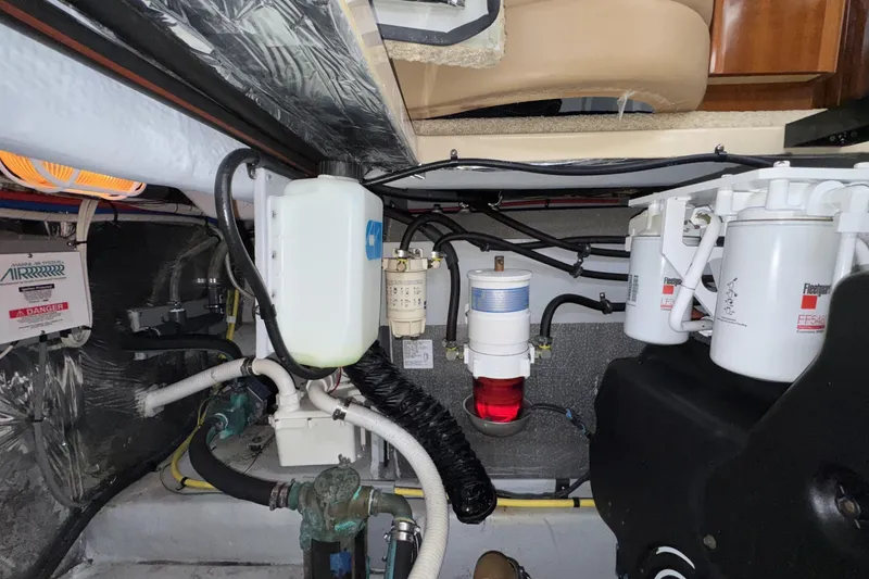 Slide: The Image of Engine room of 2007 Meridian 459 Motoryacht with fuel filters and hoses visible. - 54
