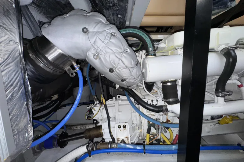 Slide: The Image of Engine room of a 2007 Meridian 459 Motoryacht with visible pipes and insulation. - 57