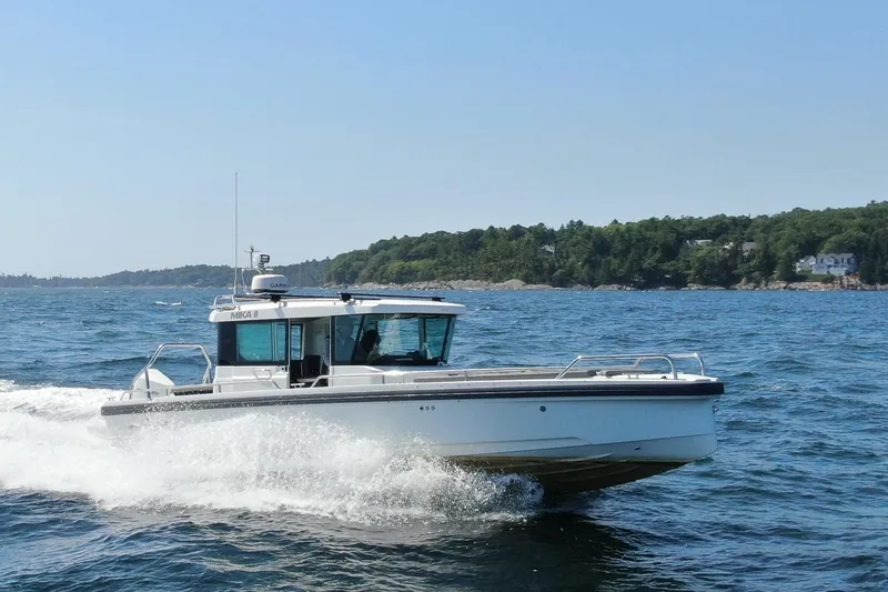 Slide: The Image of 2020 Axopar 28 Cabin boat cruising on the sea. - 1