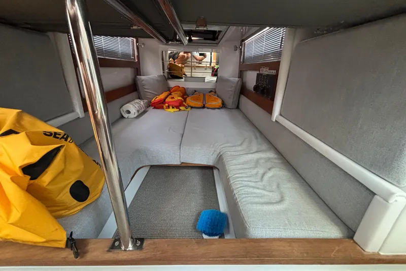 Slide: The Image of 2020 Axopar 29 Aft Cabin interior with seating, cushions, and life jackets. - 17
