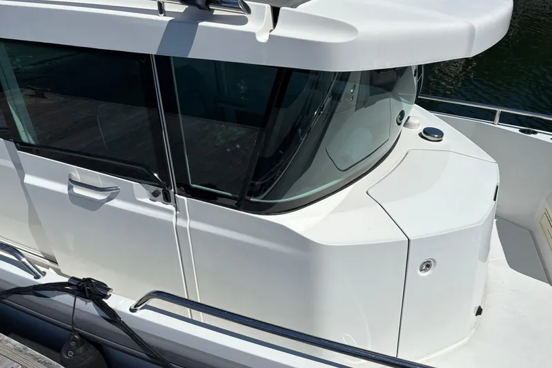 Slide: The Image of 2020 Axopar 29 Aft Cabin boat with sleek white exterior and modern design. - 9