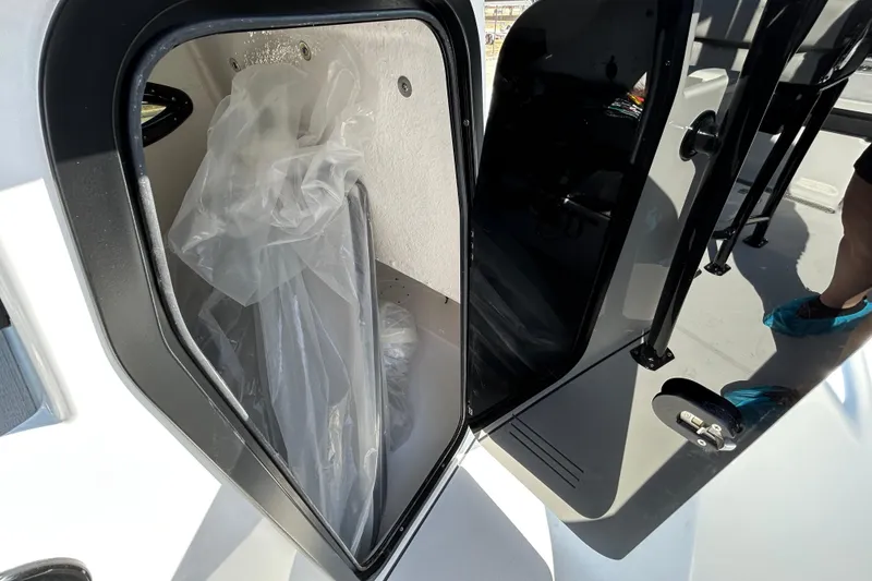 Slide: The Image of 2026 Sea Pro 250 Bay boat storage compartment with protective covering inside. - 16
