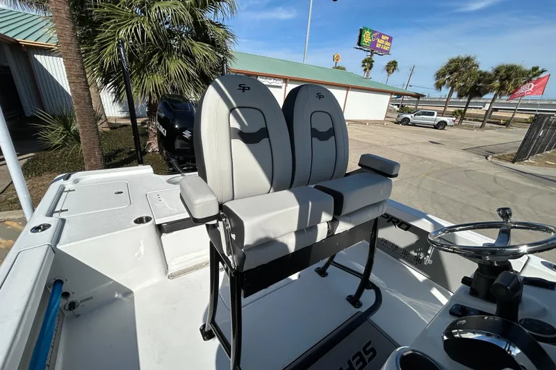 Slide: The Image of 2026 Sea Pro 250 Bay boat interior with dual seats and steering wheel. - 17