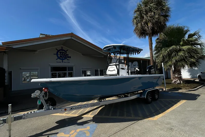 Slide: The Image of 2026 Sea Pro 250 Bay boat on trailer outside Gulf Coast Marine dealership. - 2