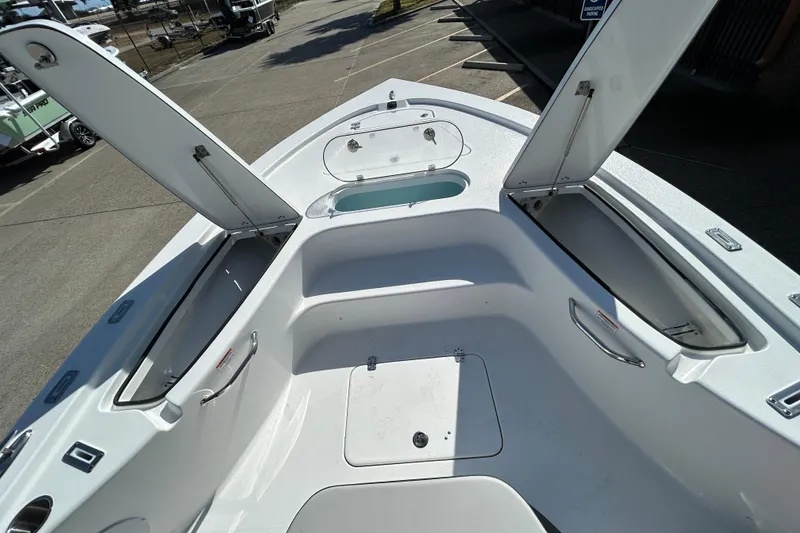 Slide: The Image of 2026 Sea Pro 250 Bay boat interior with open storage compartments and seating area. - 21