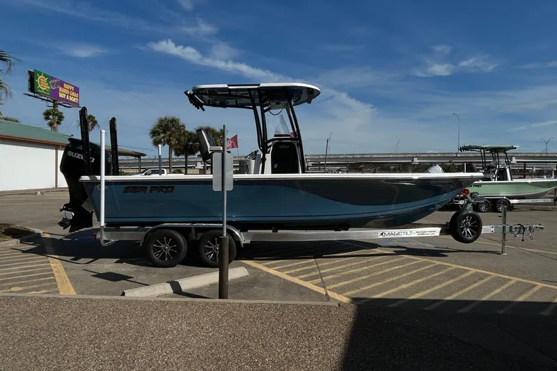 Slide: The Image of 2026 Sea Pro 250 Bay boat on trailer in parking lot under clear sky. - 4