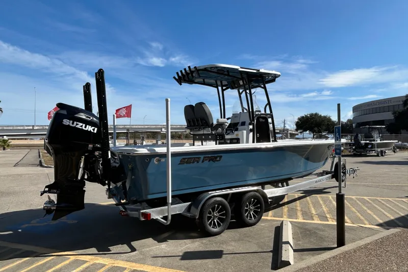 Slide: The Image of 2026 Sea Pro 250 Bay boat with Suzuki engine on trailer in parking lot. - 5