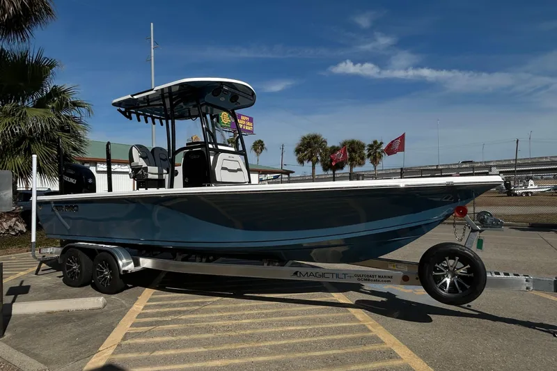 Slide: The Image of 2026 Sea Pro 250 Bay boat on trailer, parked outdoors under clear blue sky. - 8