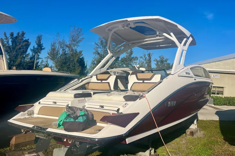 Slide: The Image of 2021 Yamaha Boats 275SD in water, surrounded by lush greenery. - 1