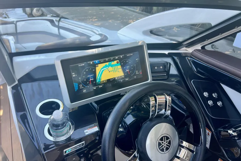 Slide: The Image of 2021 Yamaha Boats 275SD dashboard with touchscreen display and steering wheel. - 11
