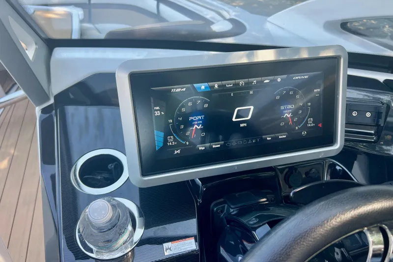 Slide: The Image of Dashboard of 2021 Yamaha Boats 275SD with digital display and cup holder. - 13