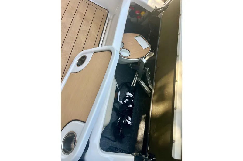 Slide: The Image of 2021 Yamaha Boats 275SD interior with wooden accents and storage compartment. - 17
