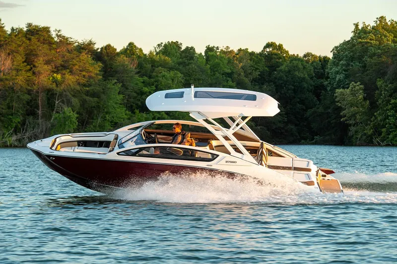 Slide: The Image of Manufacturer Provided Image: 2021 Yamaha Boats 275SD cruising on a lake with lush green trees in the background. - 23