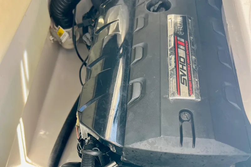 Slide: The Image of 2021 Yamaha Boats 275SD on display, sleek design, parked on grass under clear blue sky. - 4