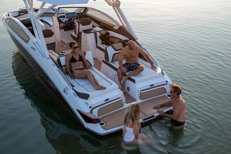 Slide: The Image of 2021 Yamaha Boats 275SD docked, showcasing sleek design and spacious seating. - 6