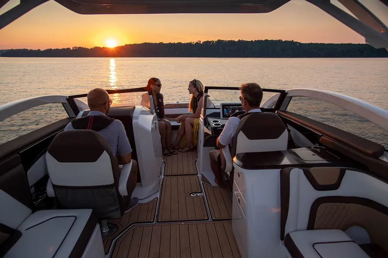 Slide: The Image of 2021 Yamaha Boats 275SD interior view at dock, showcasing luxury seating and design. - 9