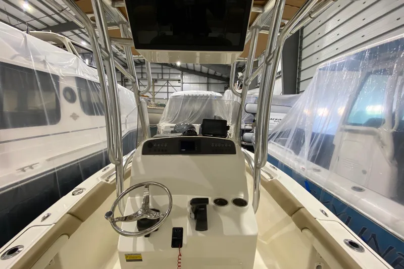 Slide: The Image of 2019 Pioneer 202 Islander boat interior in storage, featuring steering console and controls. - 11
