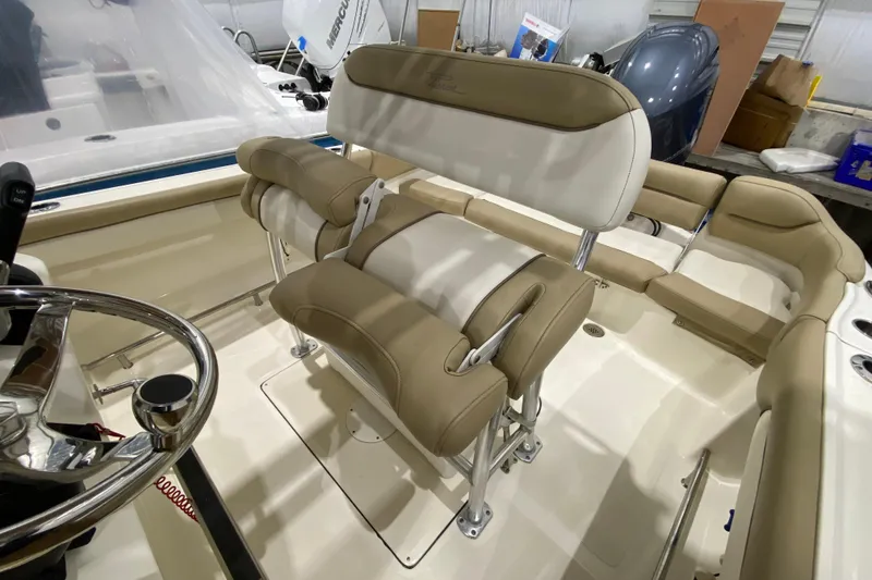 Slide: The Image of 2019 Pioneer 202 Islander boat interior with beige seating and steering wheel. - 12