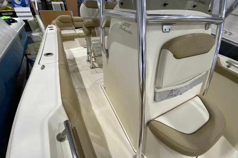 Slide: The Image of 2019 Pioneer 202 Islander boat interior with beige seating and stainless steel railings. - 15