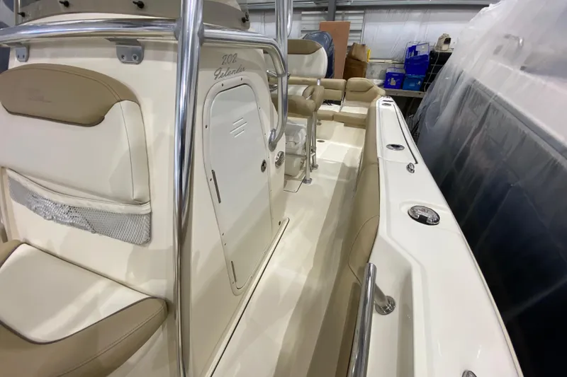 Slide: The Image of 2019 Pioneer 202 Islander boat interior with beige seating and stainless steel railings. - 16