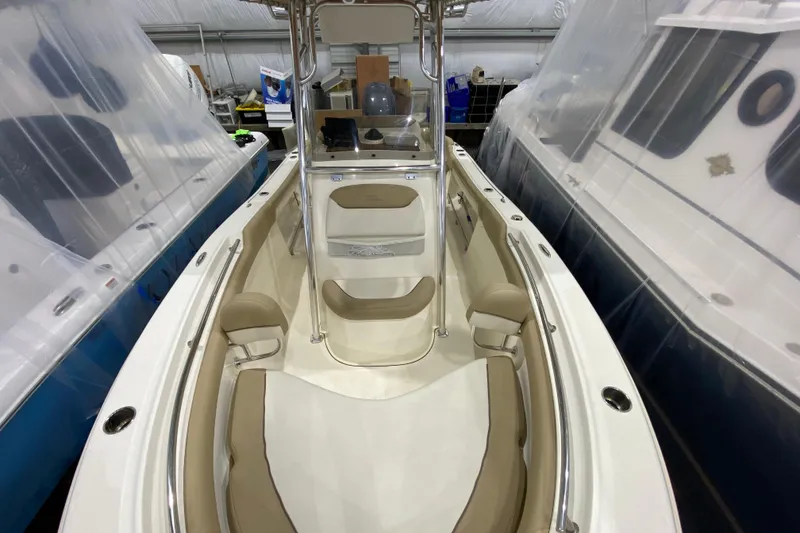 Slide: The Image of 2019 Pioneer 202 Islander boat interior with beige seating and center console. - 17