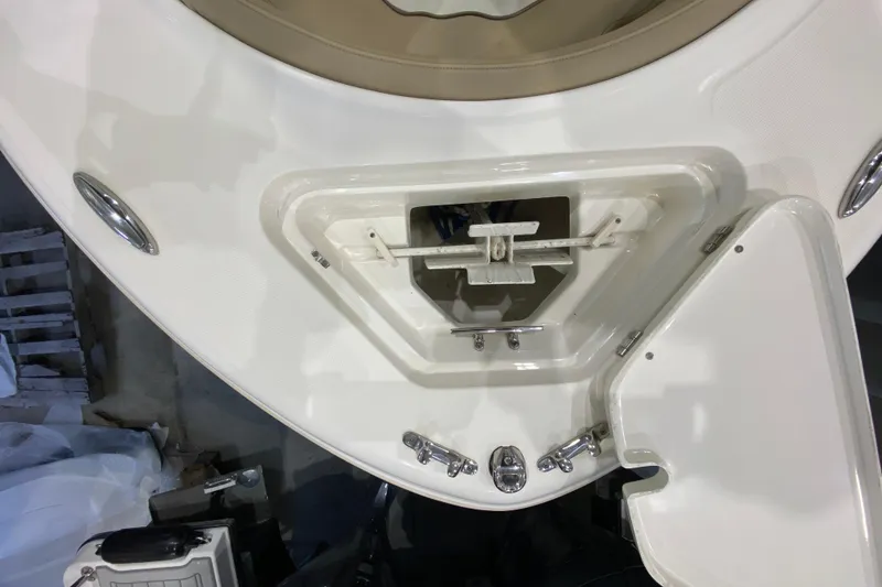 Slide: The Image of 2019 Pioneer 202 Islander boat anchor compartment with open hatch and stainless steel fittings. - 18