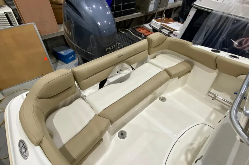 Slide: The Image of 2019 Pioneer 202 Islander boat interior with beige seating and Yamaha 150 engine. - 9
