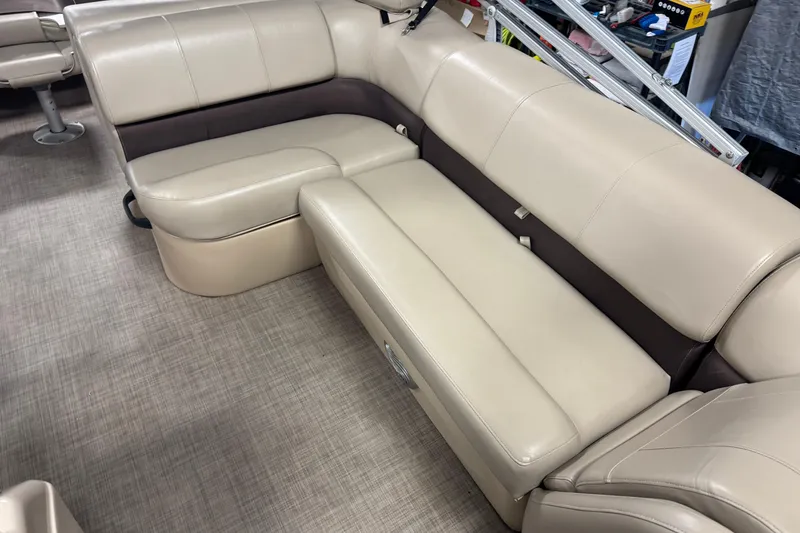 Slide: The Image of 2019 Sun Tracker Fishin' Barge 22 XP3 interior seating, beige upholstery, spacious layout. - 11