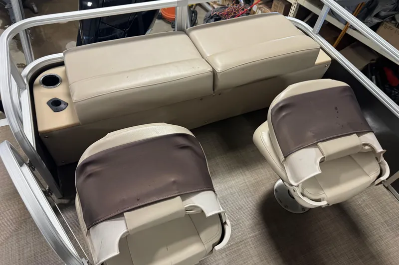 Slide: The Image of 2019 Sun Tracker Fishin' Barge 22 XP3 interior with beige seating and cup holder. - 17