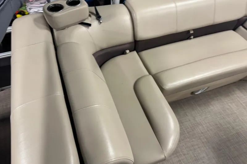 Slide: The Image of 2019 Sun Tracker Fishin' Barge 22 XP3 beige seating with cup holders, interior view. - 20