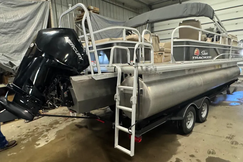Slide: The Image of 2019 Sun Tracker Fishin' Barge 22 XP3 pontoon boat with Mercury outboard engine in a garage. - 4